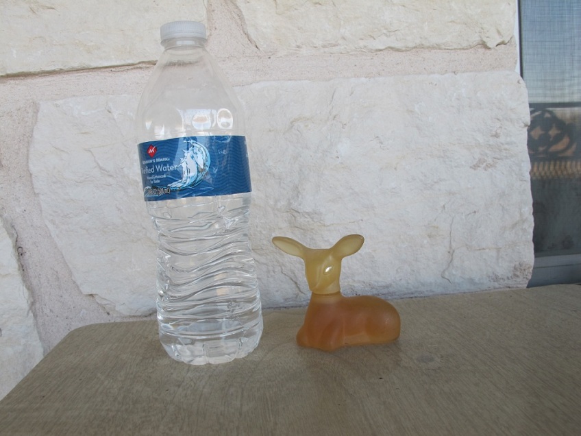 Avon deer bottle with a water bottle for size comparison